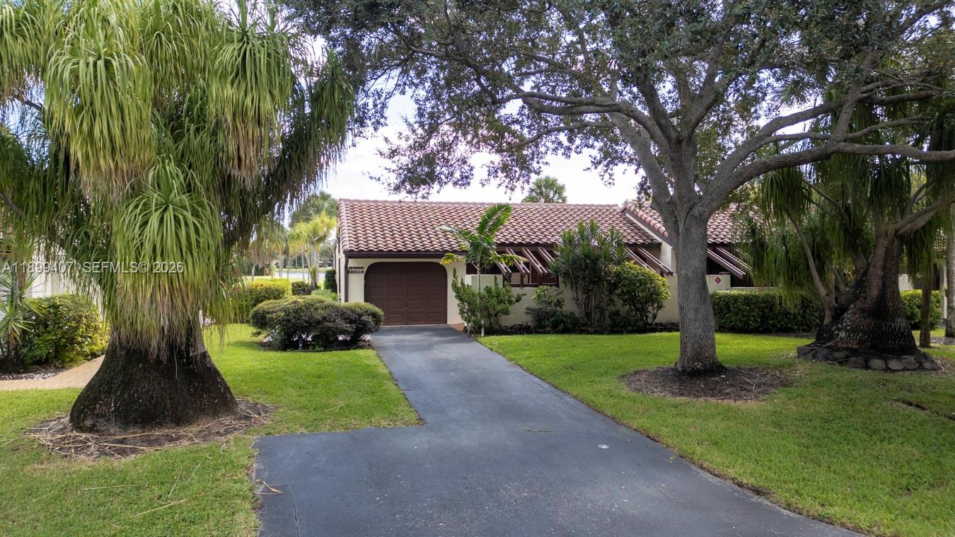 21686 Arriba Real, Unit 40A Boca Raton, FL 33433 - Photo 50 of 53 a front view of a house with garden