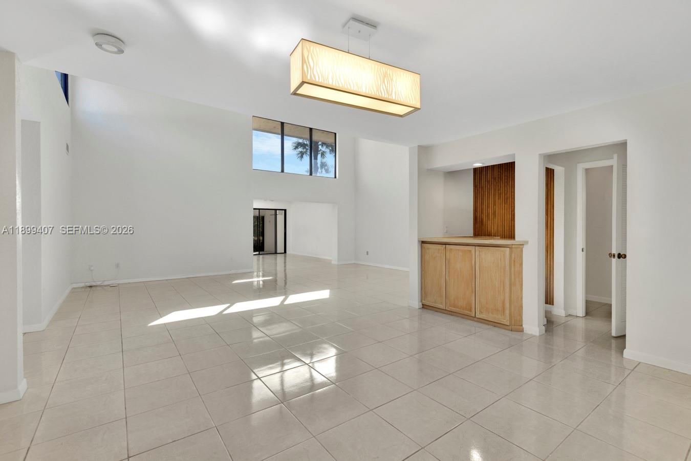 21686 Arriba Real, Unit 40A Boca Raton, FL 33433 - Photo 10 of 53 a view of a livingroom with wooden floor and a refrigerator