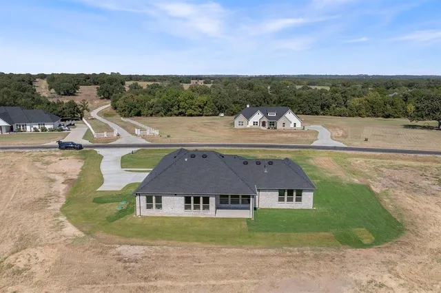 a aerial view of a house with a big yard