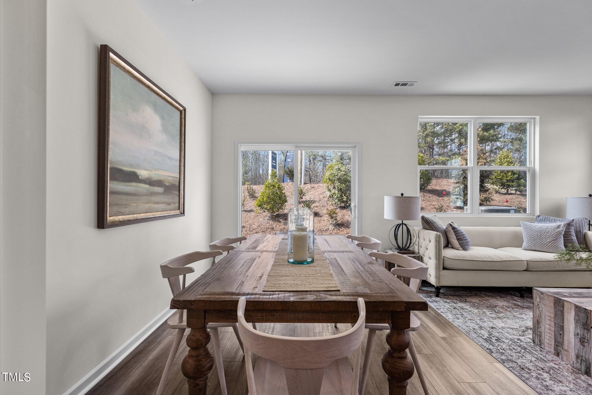 130 South Chubb Ridge Clayton, NC 27520 - Photo 11 of 32 a view of a dining room with furniture large window and wooden floor