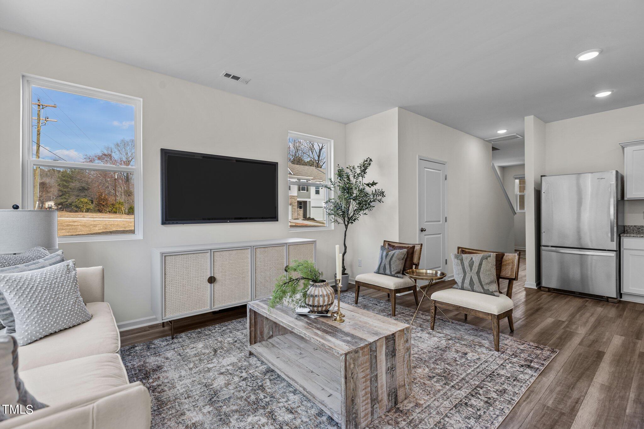 130 South Chubb Ridge Clayton, NC 27520 - Photo 13 of 32 a living room with furniture and a flat screen tv