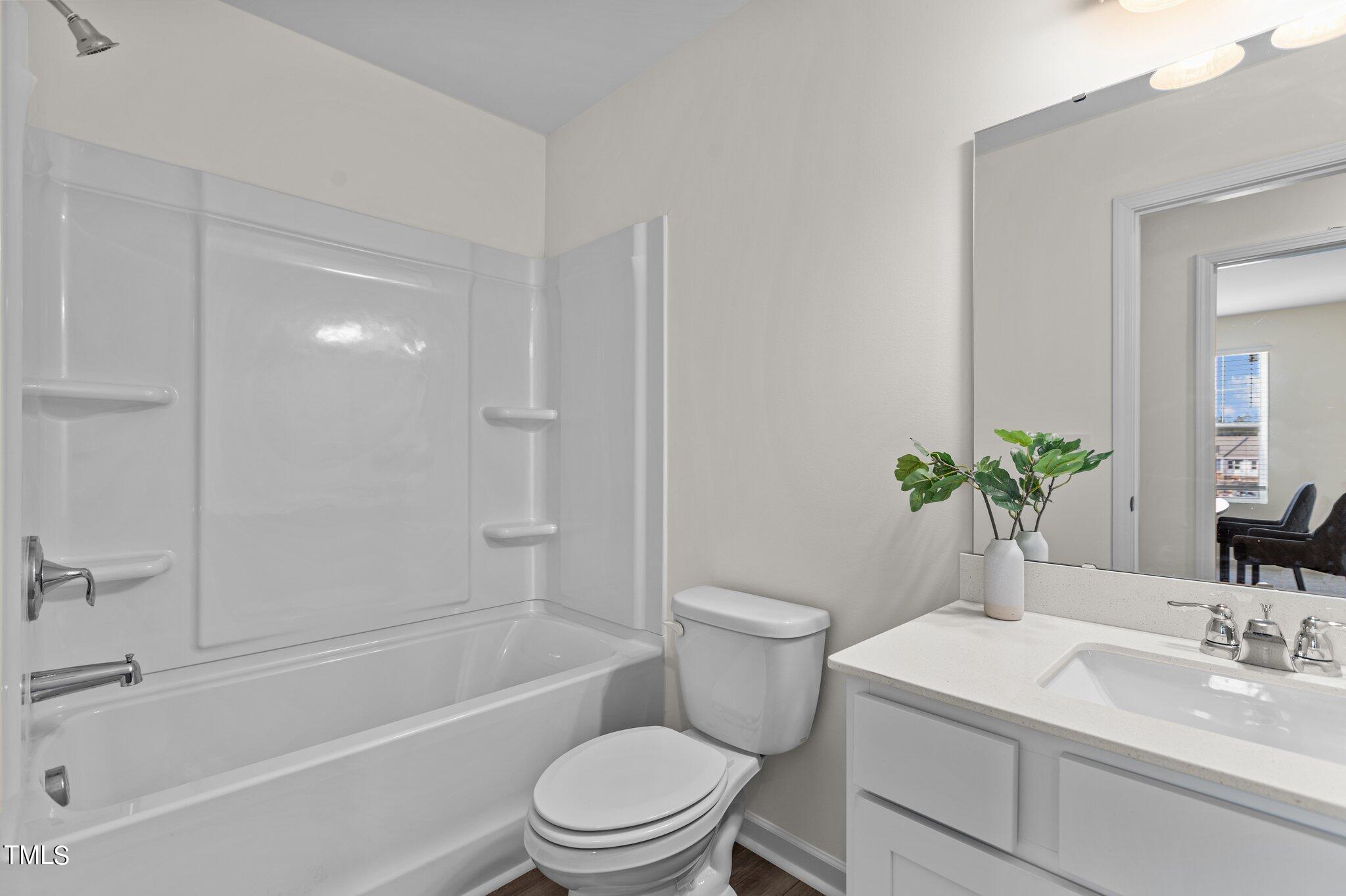 130 South Chubb Ridge Clayton, NC 27520 - Photo 22 of 32 a bathroom with a sink a toilet and shower