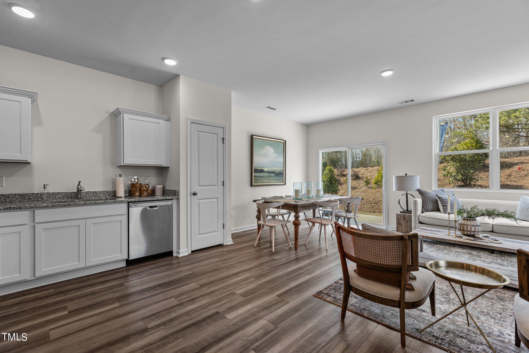 130 South Chubb Ridge Clayton, NC 27520 - Photo 7 of 32 a kitchen with a dining table chairs and refrigerator