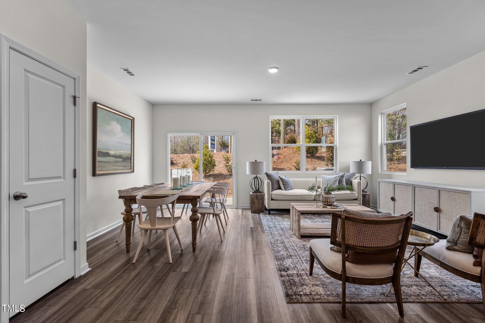 130 South Chubb Ridge Clayton, NC 27520 - Photo 10 of 32 a living room with furniture a window and a flat screen tv