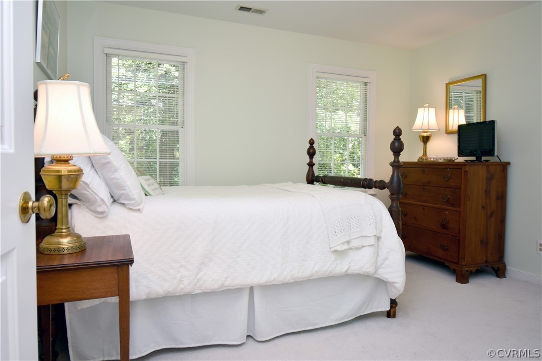 8331 Cherokee Road Richmond, VA 23235 - Photo 24 of 47 a bedroom with a bed and wooden floor
