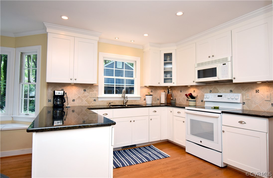 8331 Cherokee Road Richmond, VA 23235 - Photo 10 of 47 a kitchen with granite countertop white cabinets and white appliances