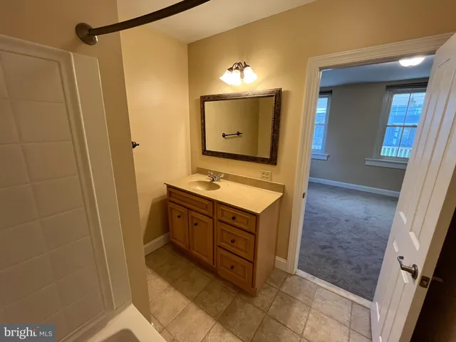 a bathroom with a tub a sink and a shower