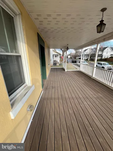 a view of front door with a sink and a mirror