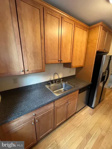 a kitchen with stainless steel appliances granite countertop wooden cabinets a sink and dishwasher