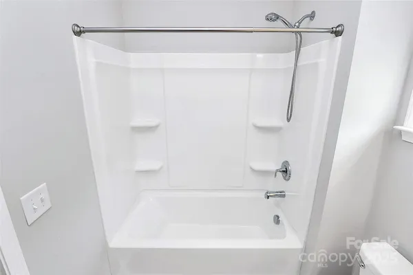 a bathroom with a shower and a bath tub