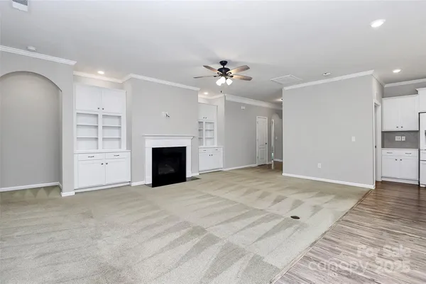 an empty room with closet and a fireplace