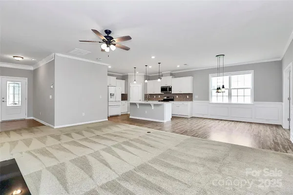 a view of an empty room with window and cabinet