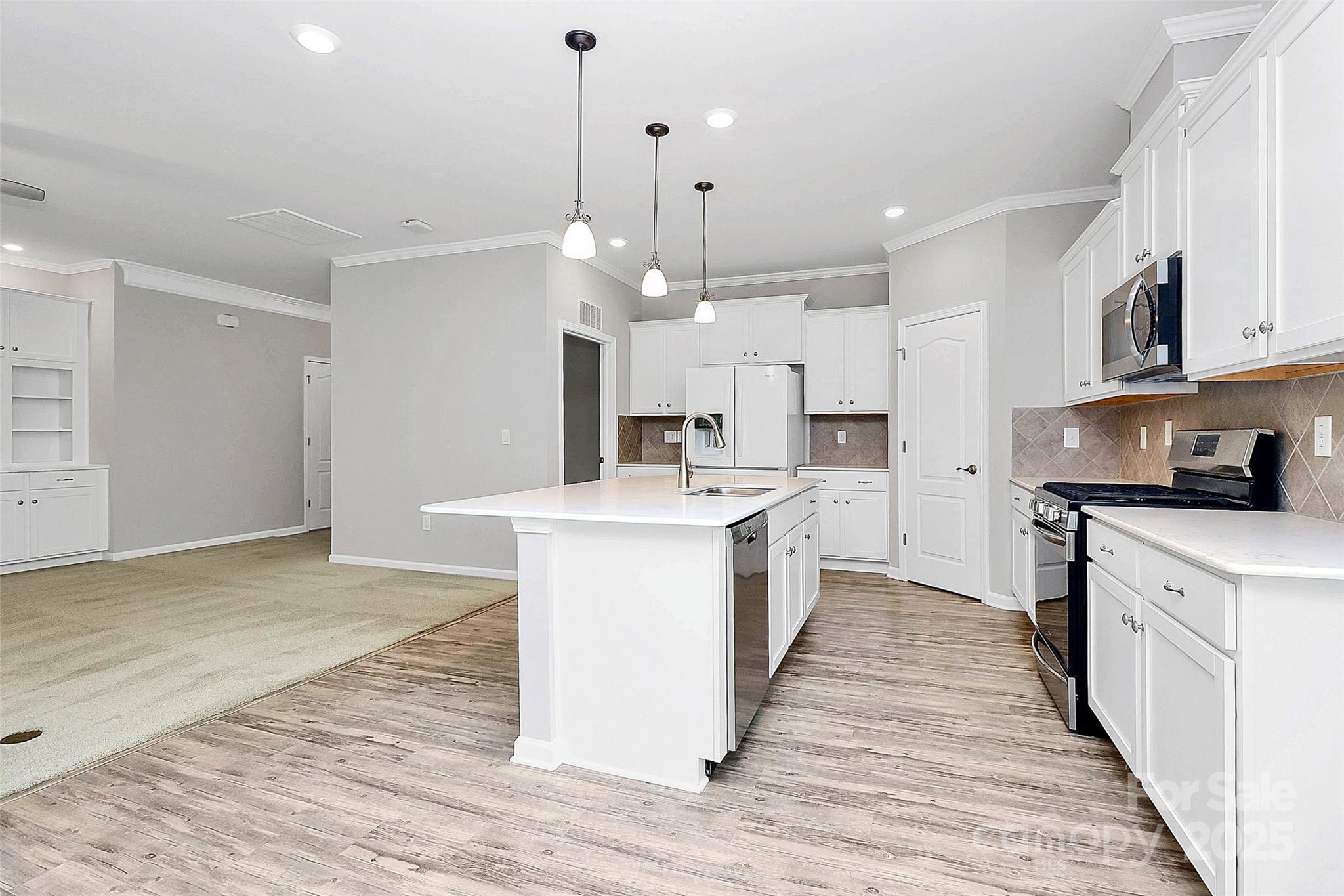 5149 Samoa Ridge Drive Lancaster, SC 29720 - Photo 22 of 40 a large kitchen with granite countertop a large counter top a sink stainless steel appliances and cabinets