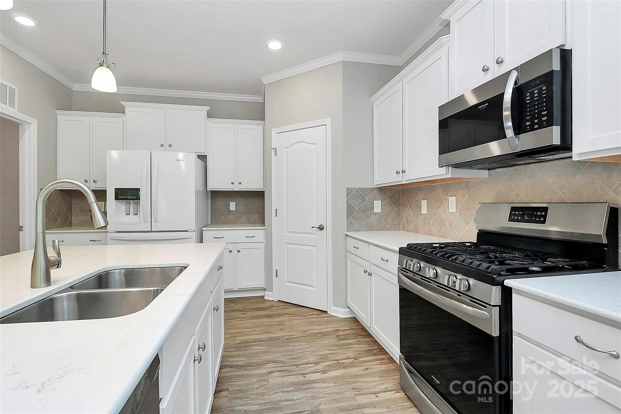 5149 Samoa Ridge Drive Lancaster, SC 29720 - Photo 25 of 40 a kitchen with granite countertop a sink a stove and microwave