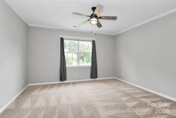 a view of room with window and ceiling fan