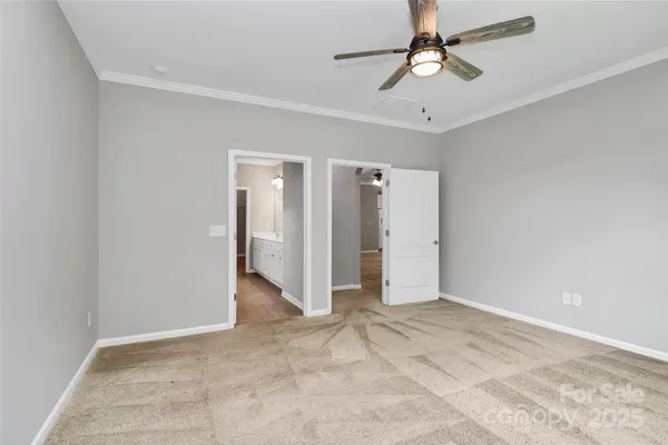 a view of empty room with ceiling fan