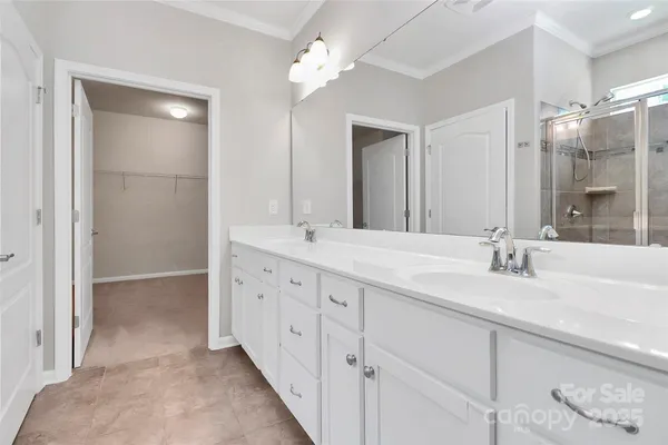 a bathroom with double vanity sink and a mirror
