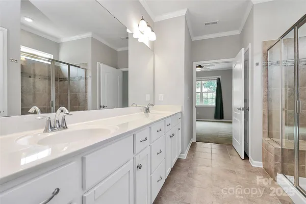 a spacious bathroom with a double vanity sink mirror and double
