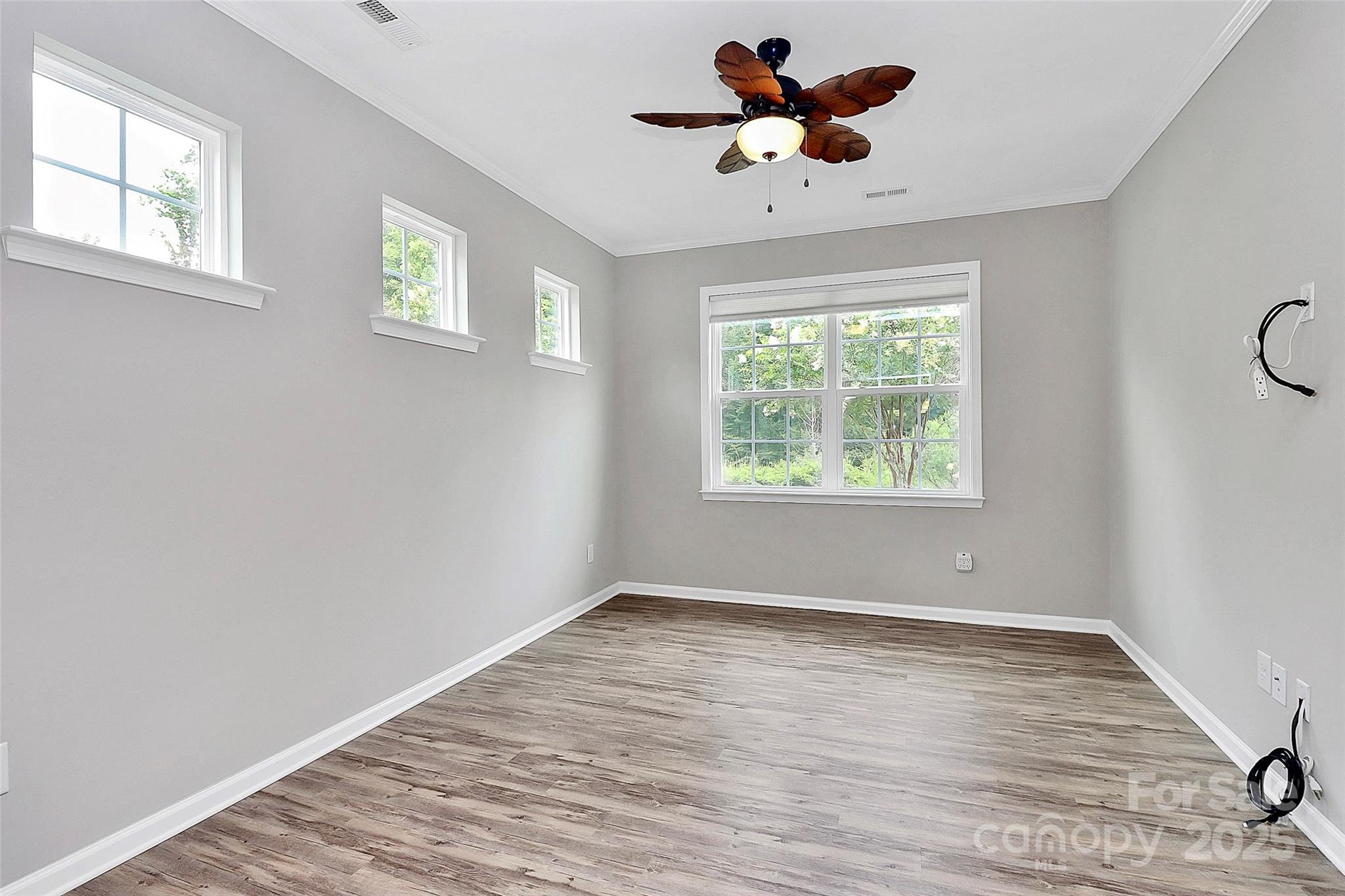 5149 Samoa Ridge Drive Lancaster, SC 29720 - Photo 33 of 40 a view of room with window ceiling fan and wooden floor