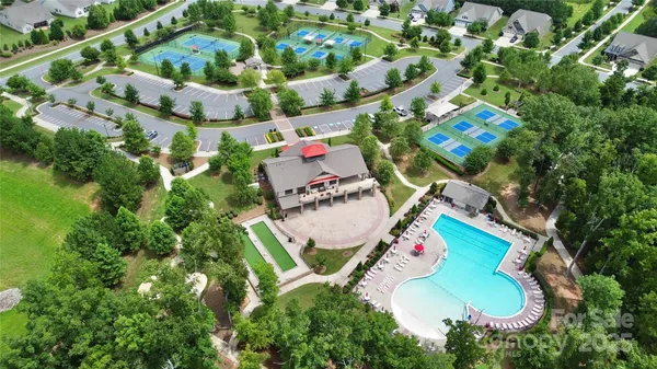 an aerial view of a swimming pool patio and outdoor seating