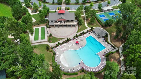 an aerial view of a house with a yard and lake view