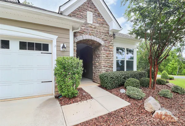 a front view of a house with garden