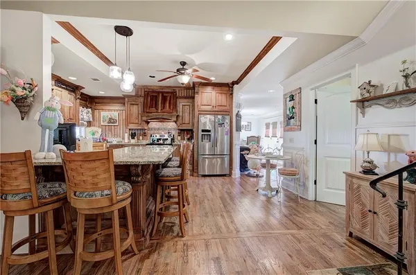a kitchen with a refrigerator and wooden floor