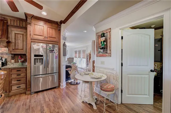 a kitchen with stainless steel appliances granite countertop a stove a sink dishwasher and cabinets with wooden floor
