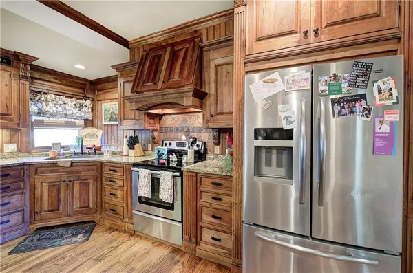 a kitchen with a table chairs sink and cabinets