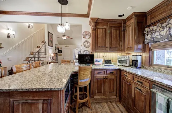 a kitchen with stainless steel appliances granite countertop a sink and cabinets