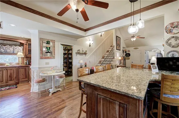 a room with lots of books and a shelf