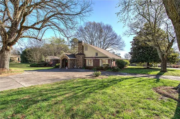 a front view of a house with yard and green space