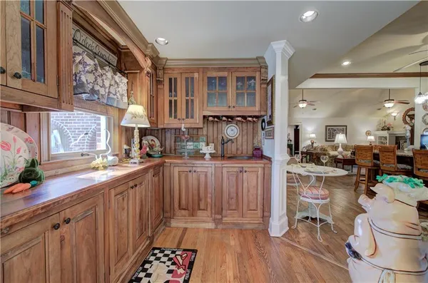 a view of a dining room with furniture a chandelier and wooden floor