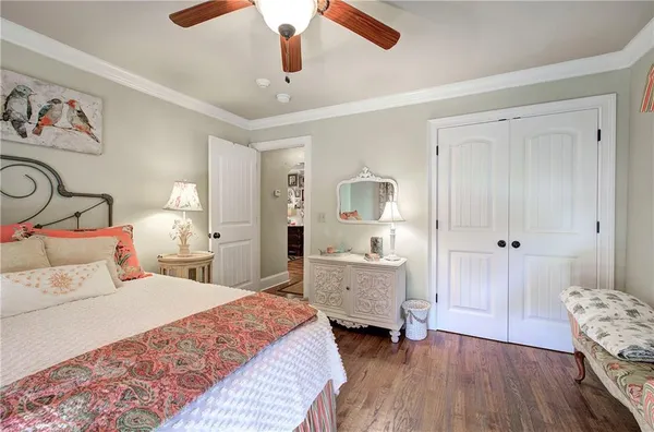 a bedroom with two beds and a chandelier