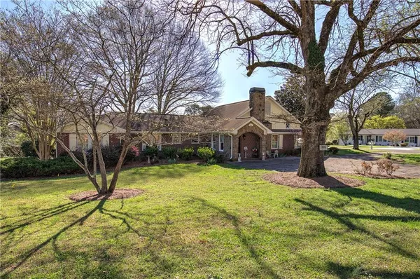 a view of a street with a large tree