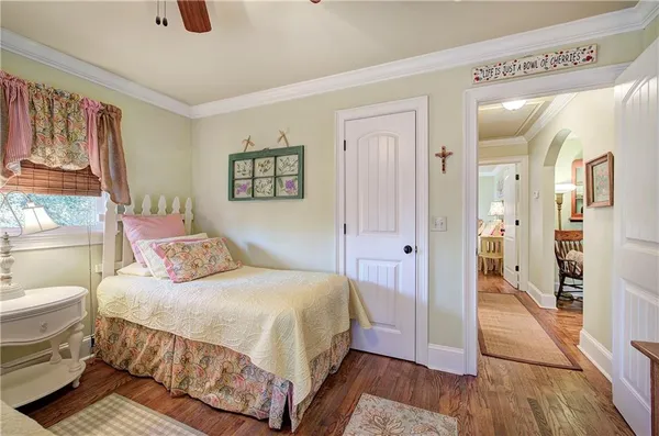 a bedroom with a large bed and dresser