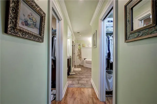 a bathroom with a tub sink and mirror
