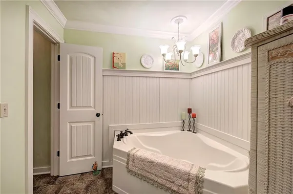 a bed room with a bed and a chair