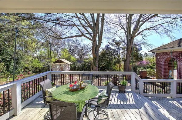 a view of a patio with couches chairs and wooden floor