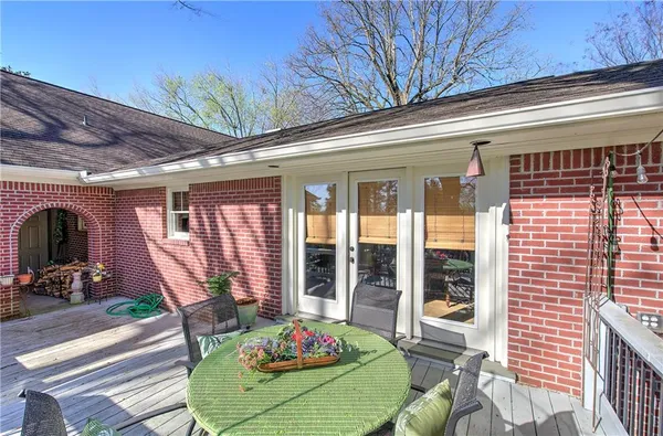 a view of a patio with table and chairs with wooden fence and floor
