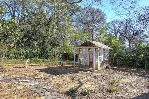a view of large trees with a yard