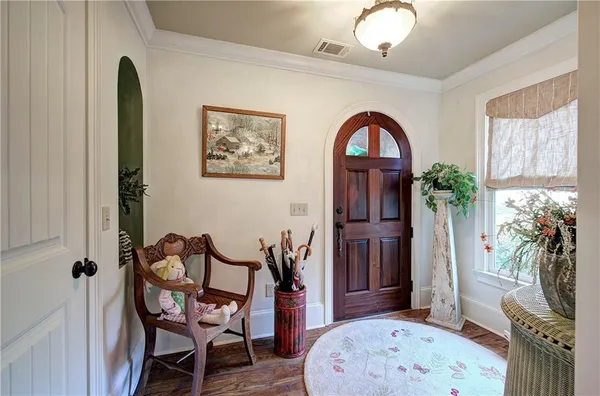 a living room with fireplace furniture and a wooden floor