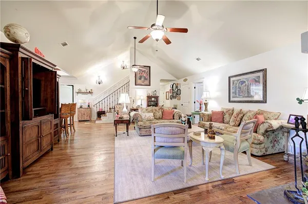 a living room with furniture a fireplace and white walls