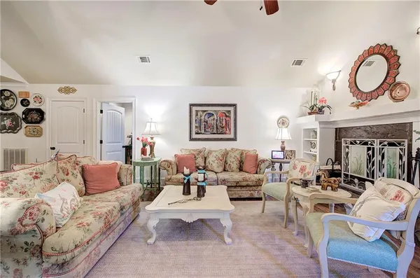 a living room with fireplace furniture and a flat screen tv