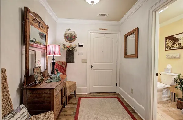 a kitchen with stainless steel appliances kitchen island granite countertop a table chairs and a refrigerator