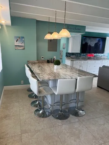 a view of a dining room with furniture and a chandelier