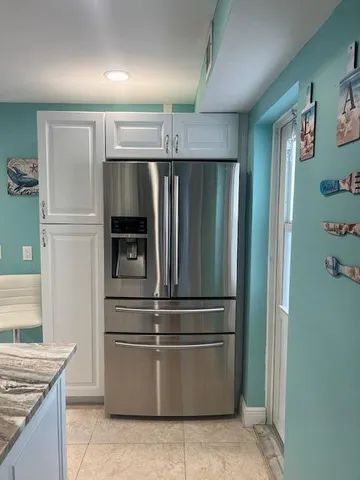 a refrigerator freezer sitting inside of a kitchen