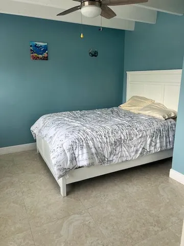a bed sitting in a bedroom next to a bathroom