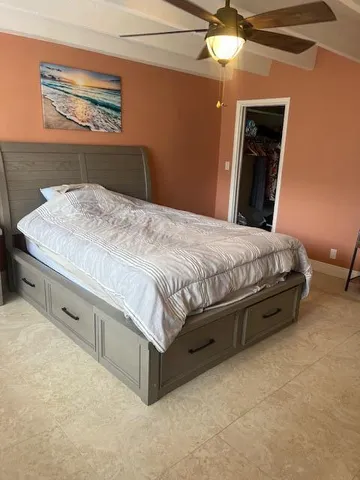 a bedroom with a bed and a chandelier