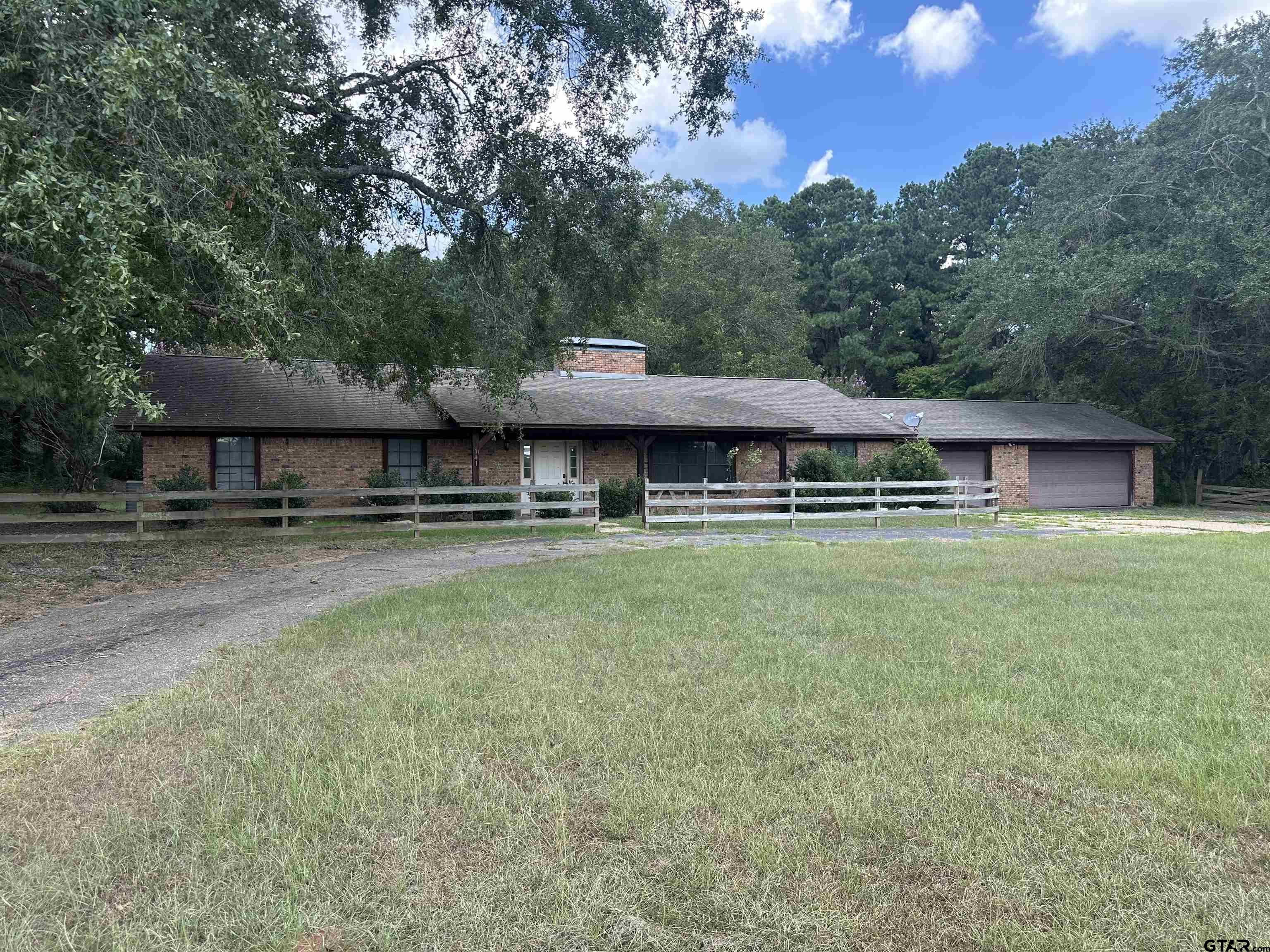 a front view of a house with a yard table and chairs